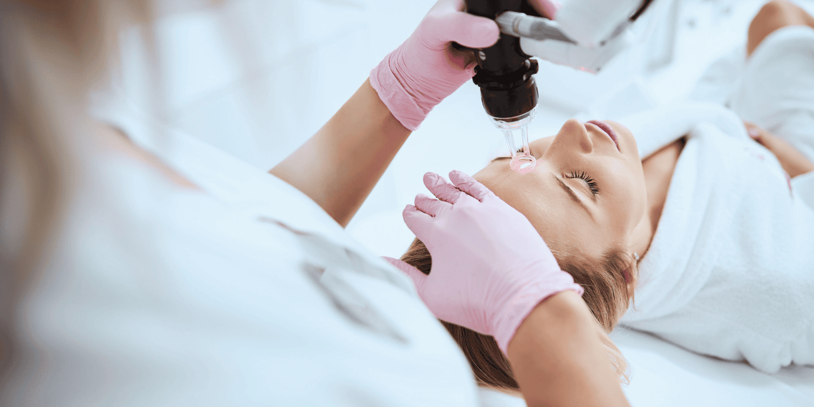 Close up image of a woman performing a CO2 laser on a paitent