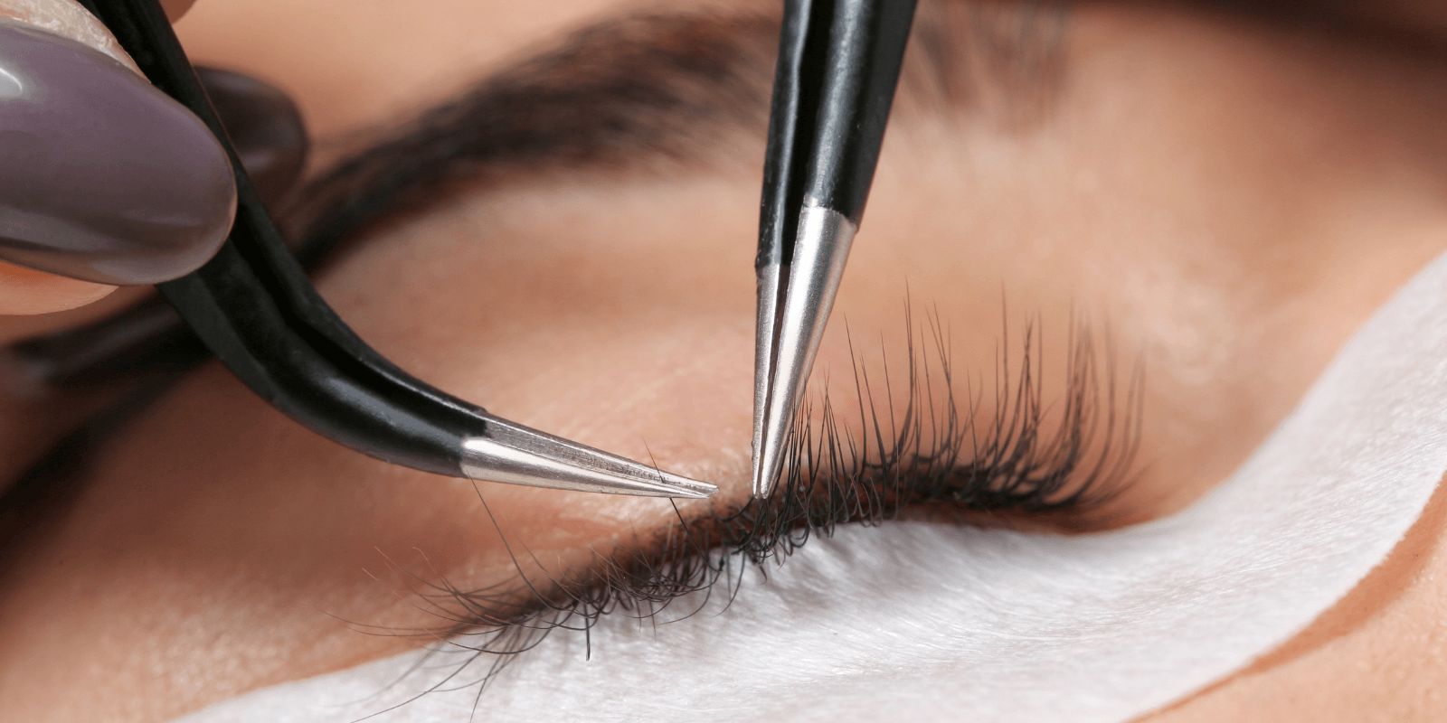 Close-up of an eyelash extension being applied