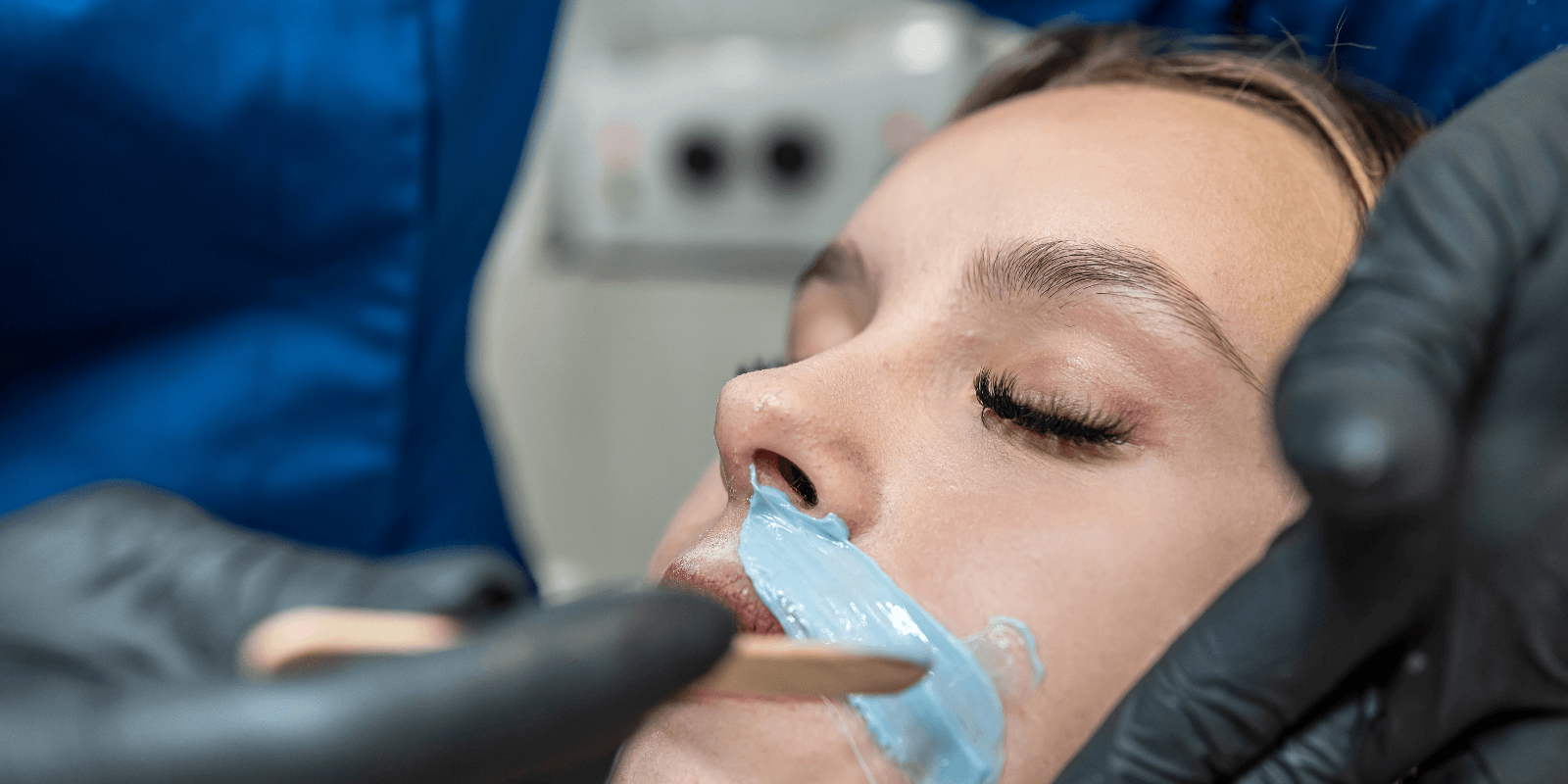 Upper lip wax being applied during a facial waxing treatment