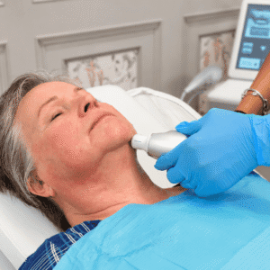 Practitioner performing an RF skin tightening treatment on a client's neck